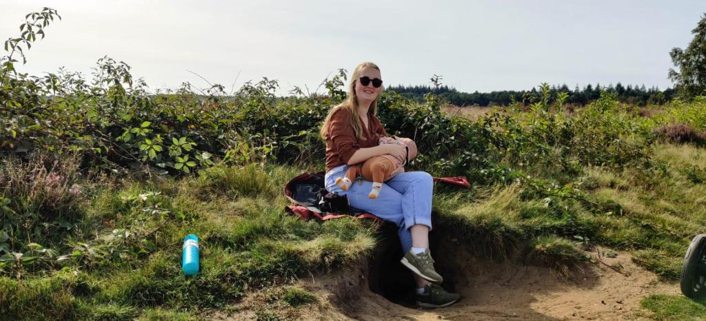 Ruimte die inspireert, waar je je vrij en op je gemak voelt. Ik op de hei in 2021, terwijl ik mijn eerste kind voed.